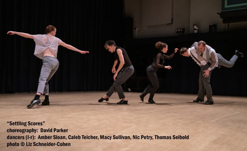 Five tap dancers stand in a line, their bodies bent. At the end of the line, Nic Petry lifts Tommy Siebold on his back.